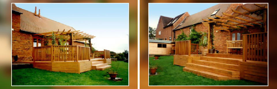 a raised decked area on the side of a house with steps leading down onto the garden 